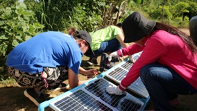 students building solar panels in Cambodia