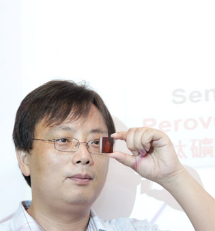 Dr Yan Feng shows his invention, semitransparent perovskite solar cells.