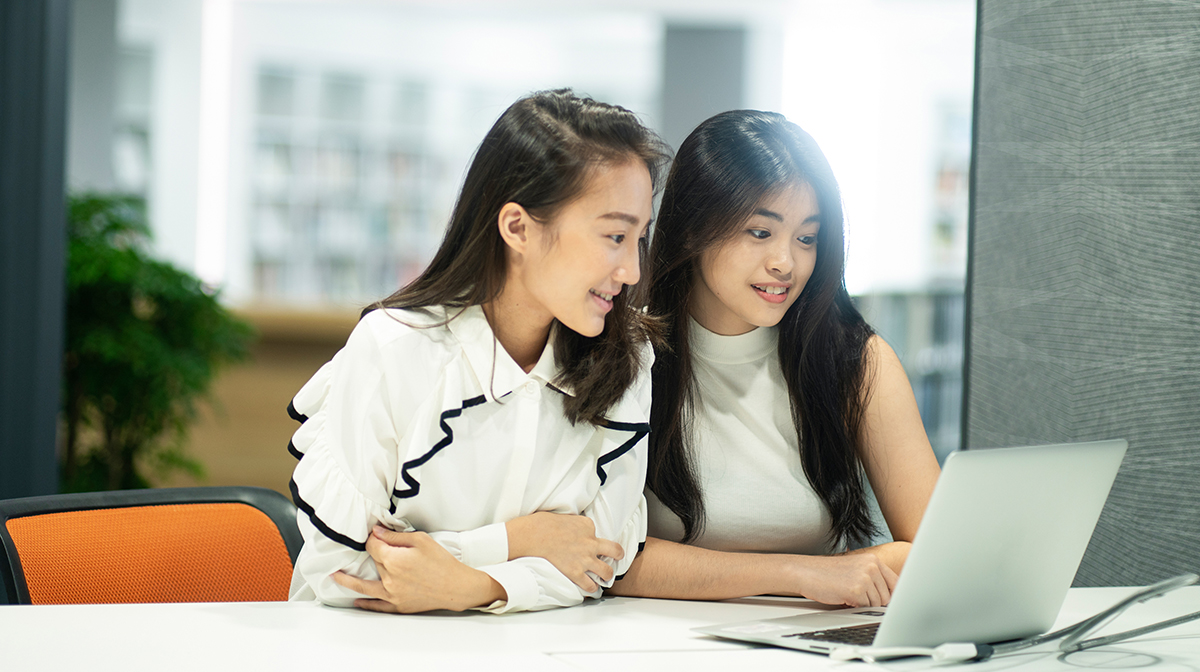 students looking at the laptop