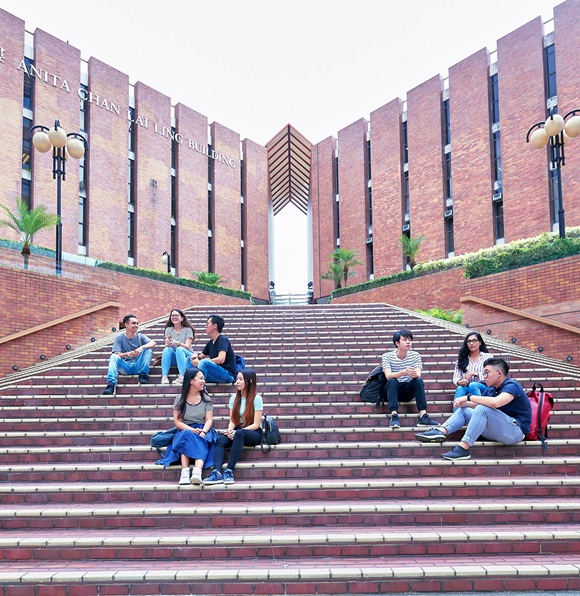 Students sitting on stairs in front of Anita Chan Lai Ling Building