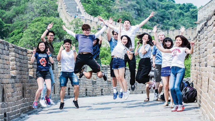 students jumping on Great Wall of China
