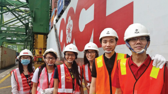 students looking at the camera when working in their internship company