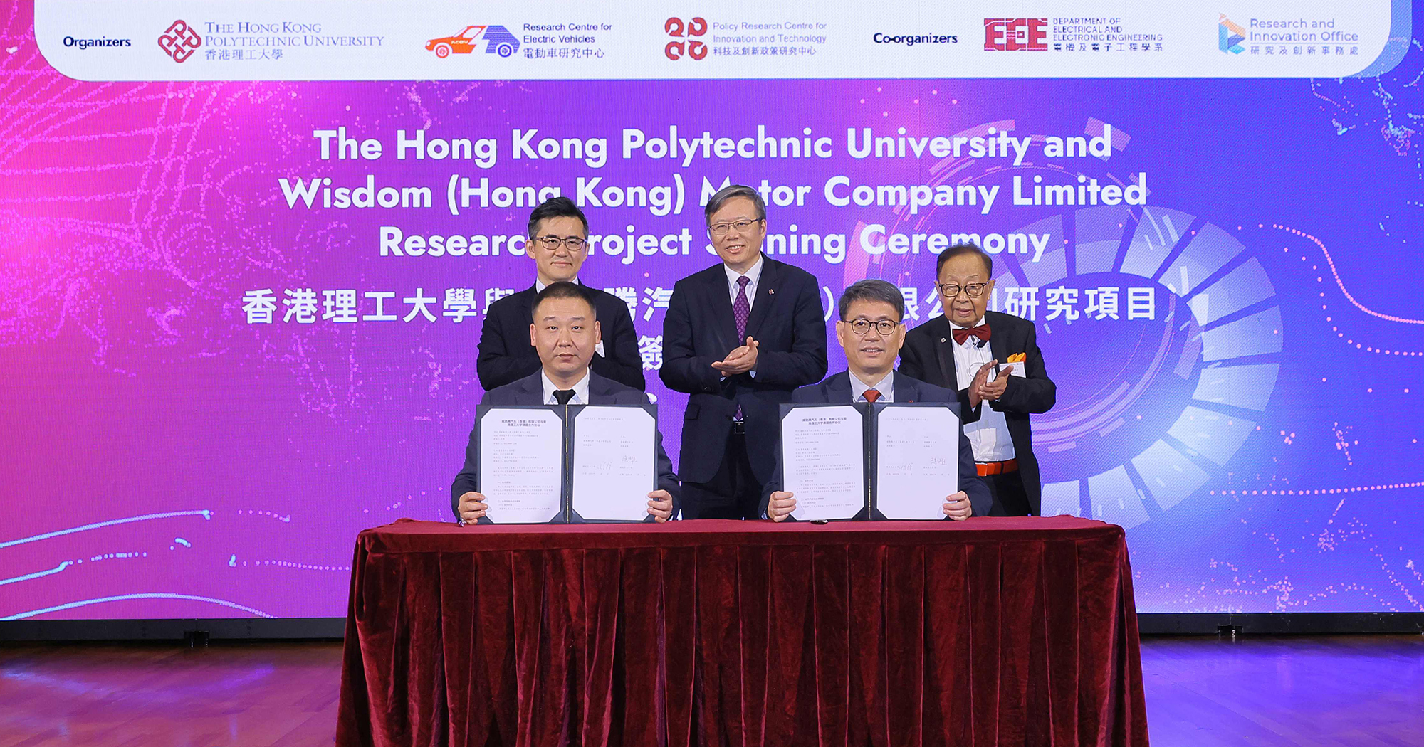 Witnessed by Prof. Jin-Guang Teng, PolyU President (centre, back row); Prof. C.C. Chan, RCEV Director (right, back row), Dr Yufeng WAN, Director of Wisdom Motor and Partner at Templewater (left, back row), an MoU was signed by Prof. Christopher Chao, PolyU Vice President (Research and Innovation), and Director of the Policy Research Centre for Innovation and Technology (right, front row); and Mr Felix XU, Chief Strategy Officer and Global Treasurer, Wisdom Motor (left, front row).