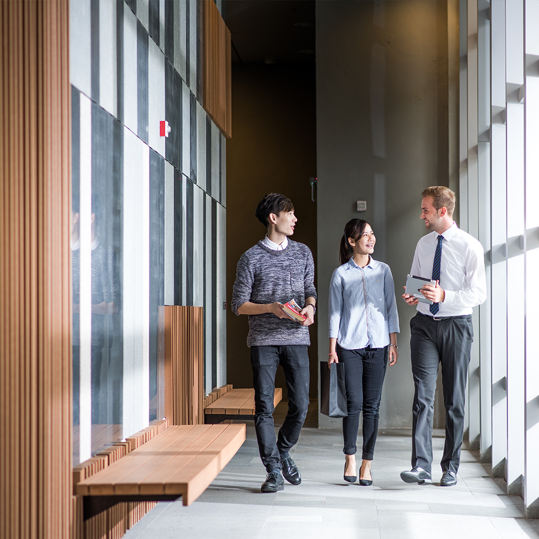 Students walking at the corridor in campus building