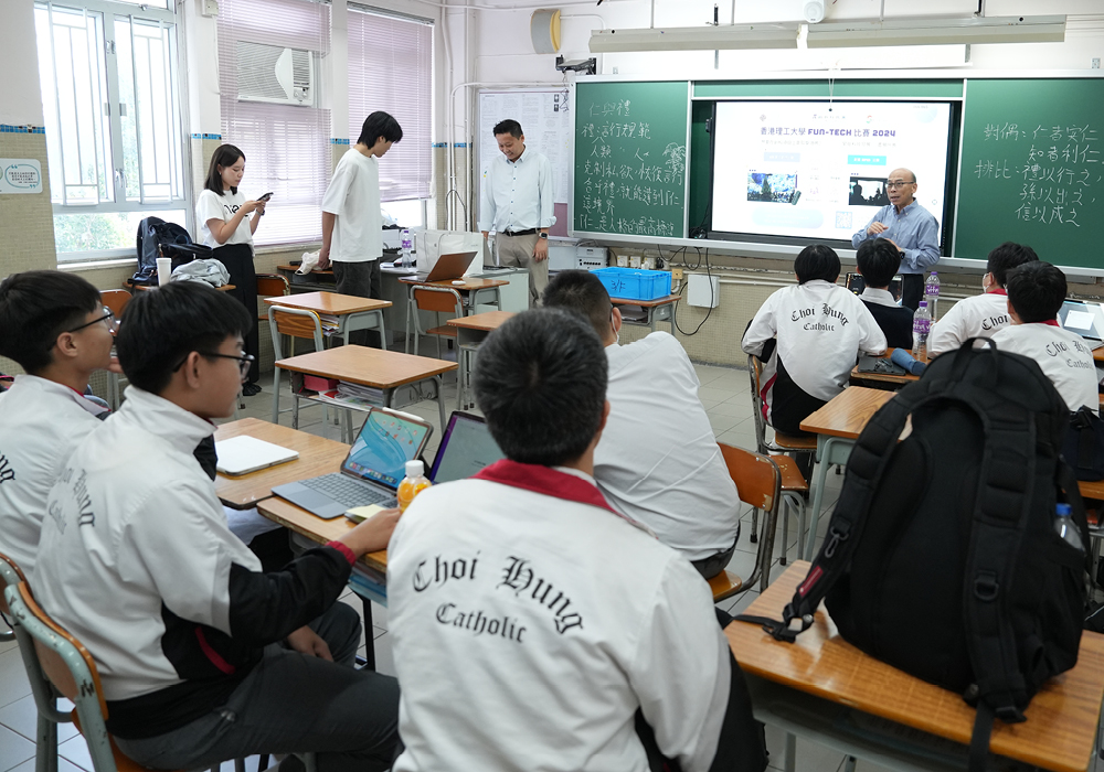 Student helpers and staff sharing in front of secondary school students