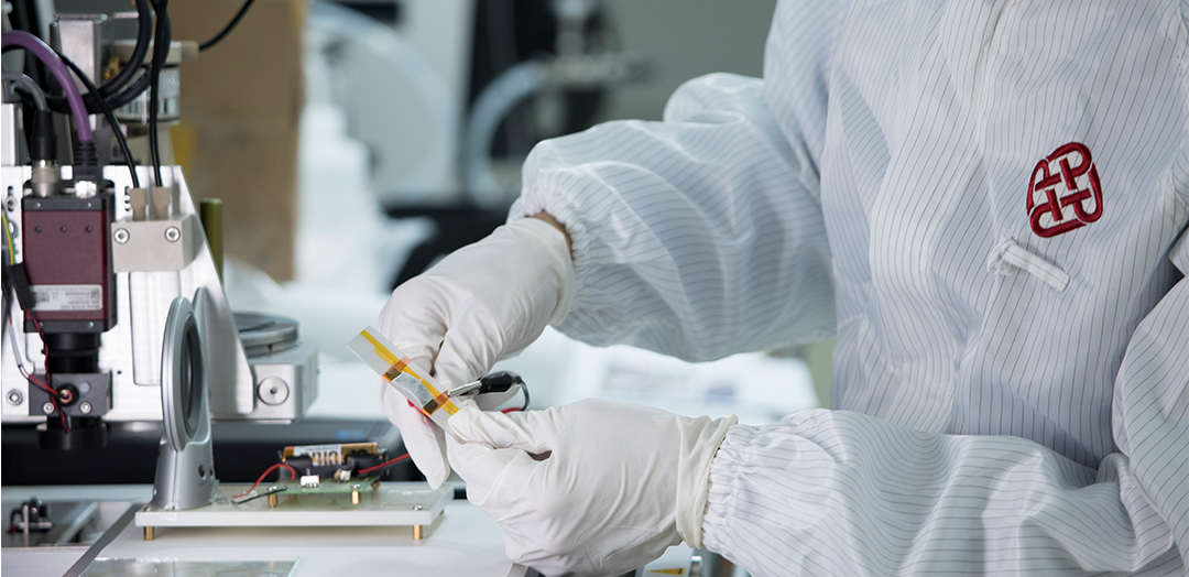 Researcher in protective wear doing experiment in laboratory