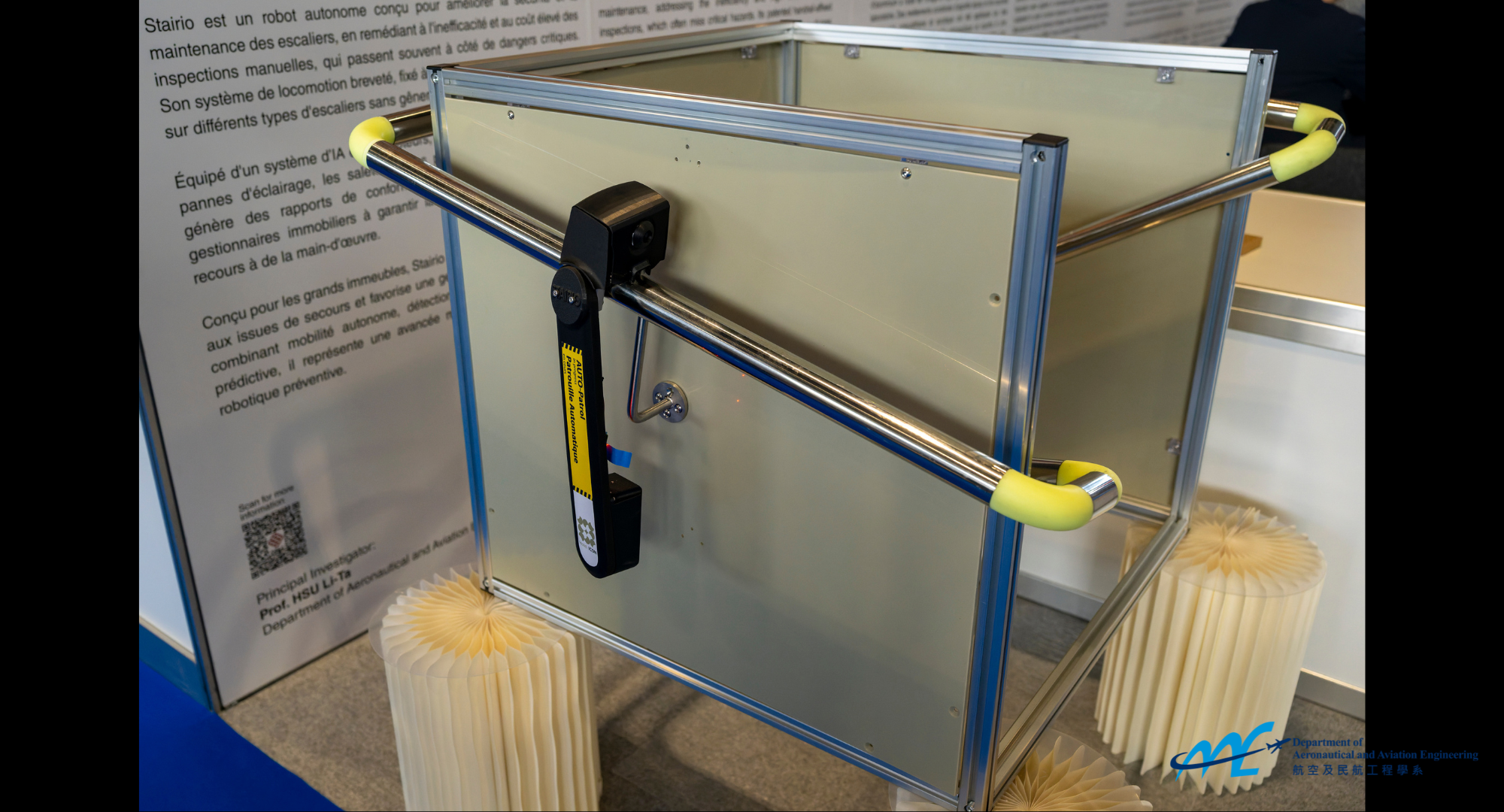 The AI-driven monitoring robot, the black robot attached to the handrail, can identify hazards and carry out maintenance through autonomous inspection.