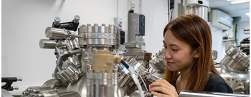 Female student looks at Laser Molecular Beam Epitaxy (LMBE)