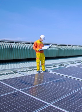 a worker checks solar panels