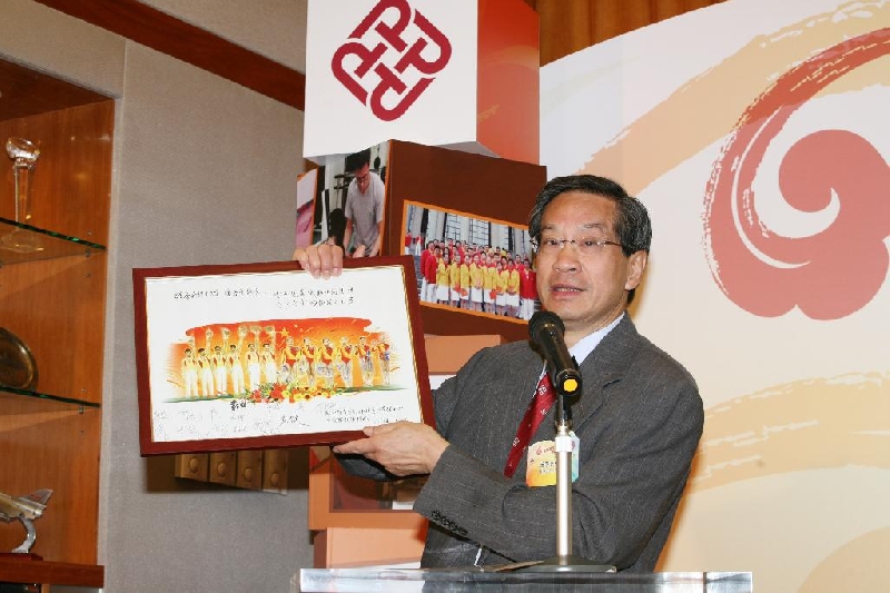 理大校长潘宗光教授展示国家体育总局体操运动管理中心及国家体操队送赠的纪念品，纪念品上有体操队员的肖像及签名。
