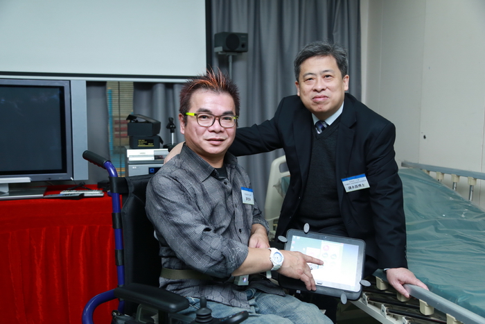 Ir Dr. Eric Tam, project coordinator of iWheelchair, demonstrates the operation of iWheelchair with a wheelchair user, Mr. Wong Wo-cahu