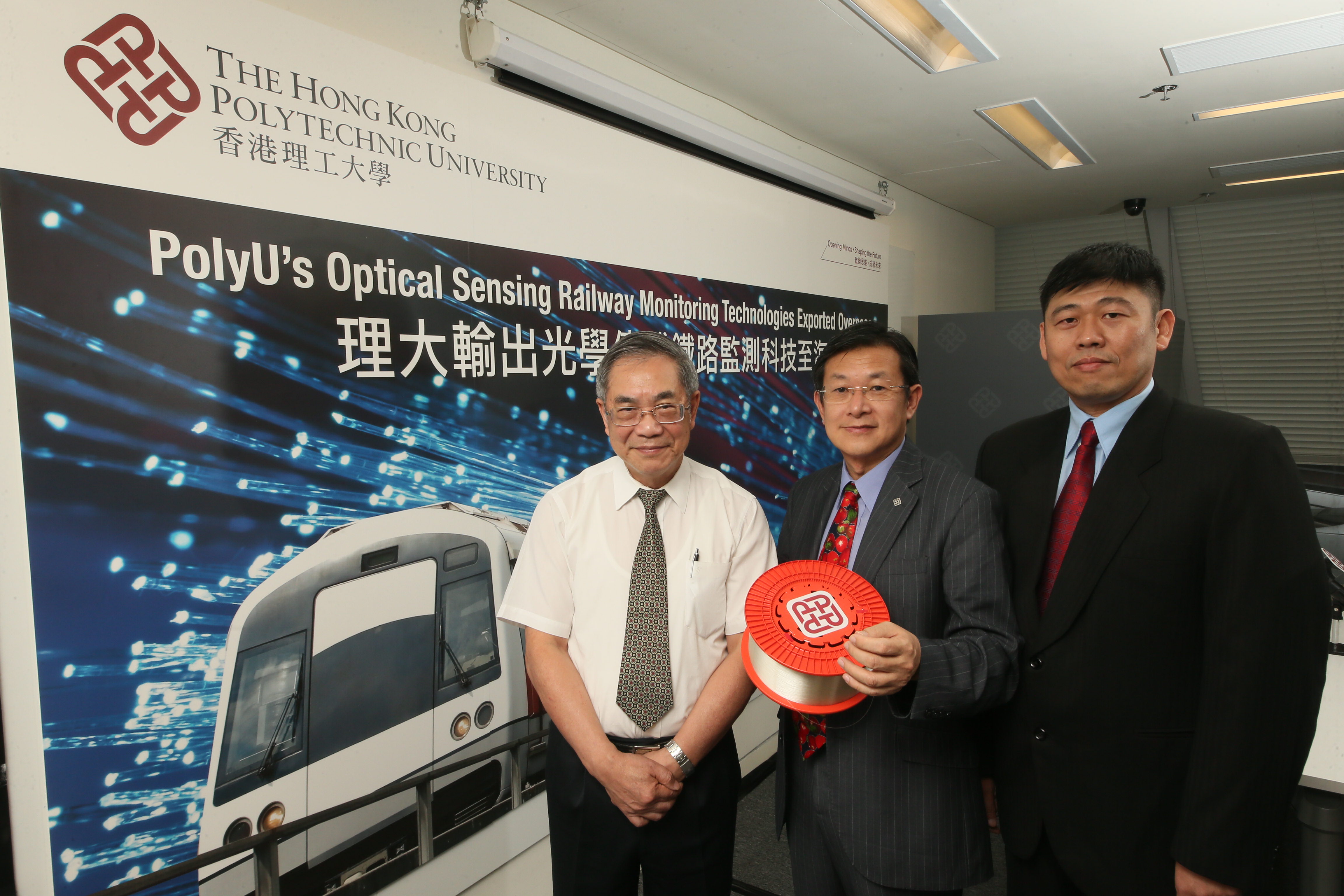 Professor Lee Kang-kuen (from left), Professor Tam Hwa-yaw and Dr Tan Chee Keong introduce the optical fibre sensing technology and the collaboration between PolyU and SMRT.