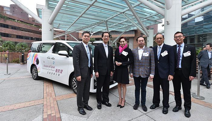 Guests in front of the mobile eye care unit transformed from a 7-seater sedan car.