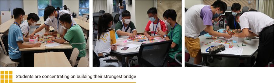 Students are concentrating on building their strongest bridge