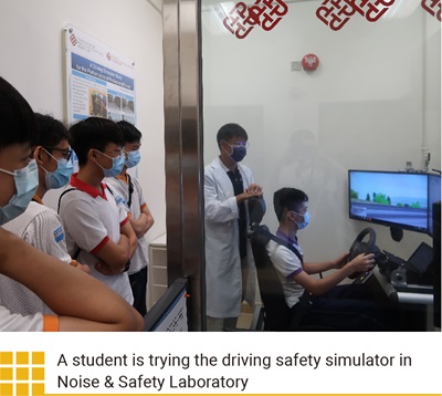 A student is trying the driving safety simulator in Noise & Safety Laboratory