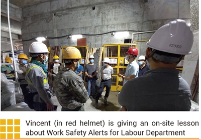Vincent (in red helmet) is giving an on-site lesson about Work Safety Alerts for Labour Department 