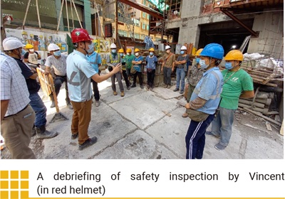 A debriefing of safety inspection by Vincent (in red helmet)