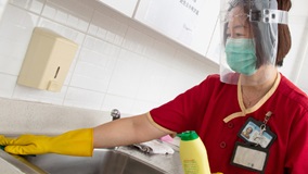 cleaners wearing face shield donated by PolyU when working on campus