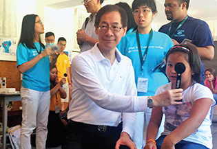 PolyU students and President Tong conducting eye checkup and vision screening for children in Tokmok.
