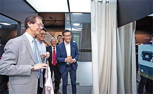 President Prof. Timothy W. Tong (first from left) experiencing the new technologies at the Fashion AI Concept
     Store. On his side are Alibaba Group Vice President Mr Zhuang Zhuo-ran, Deputy President and Provost
     Prof. Philip Chan and Institute of Textiles and Clothing Prof. Calvin Wong.
