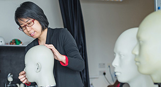 Dr Luximon Yan pictured with various 3D head templates