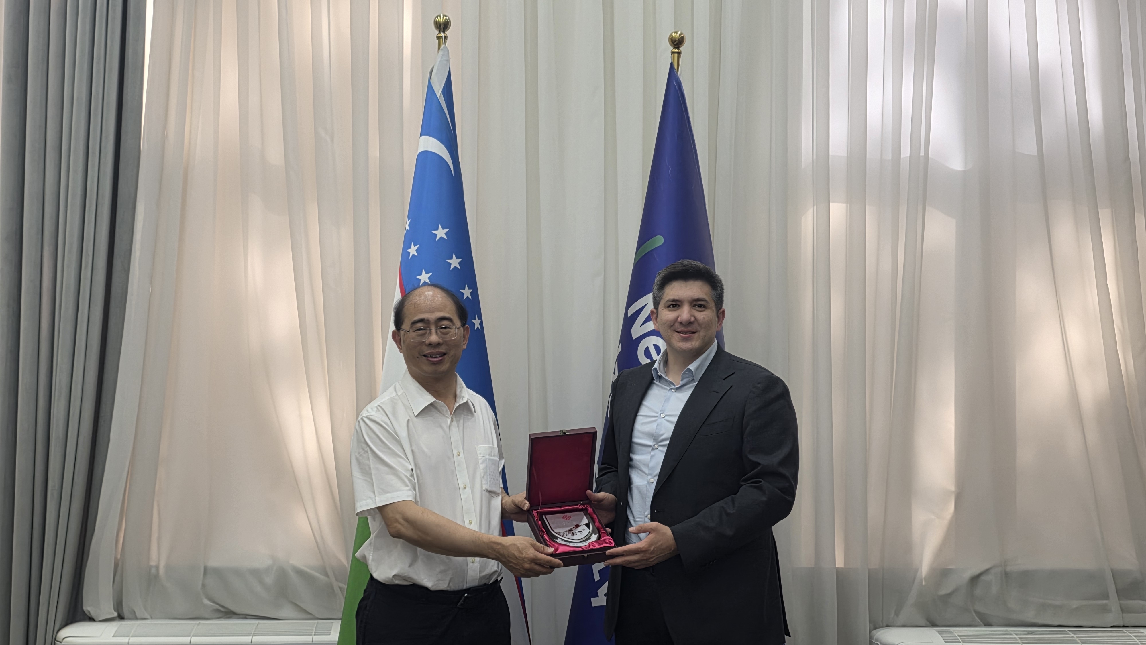 Prof. Wing-tak Wong, Deputy President and Provost (left), engaged with Dr Bahodir Ahmedov Bobomurodovich, Rector of NewUU (right).