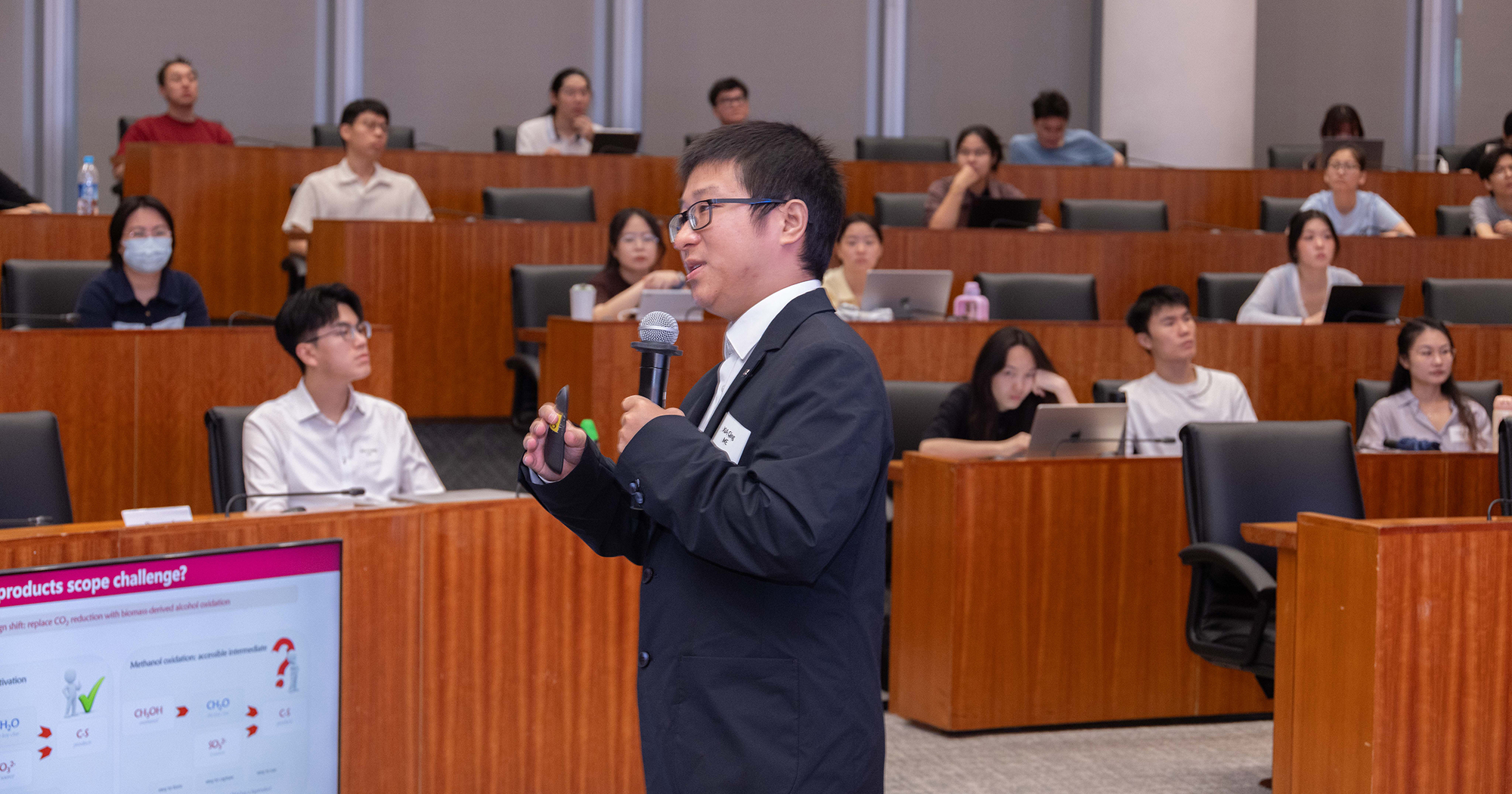 Student presents his research to the participants