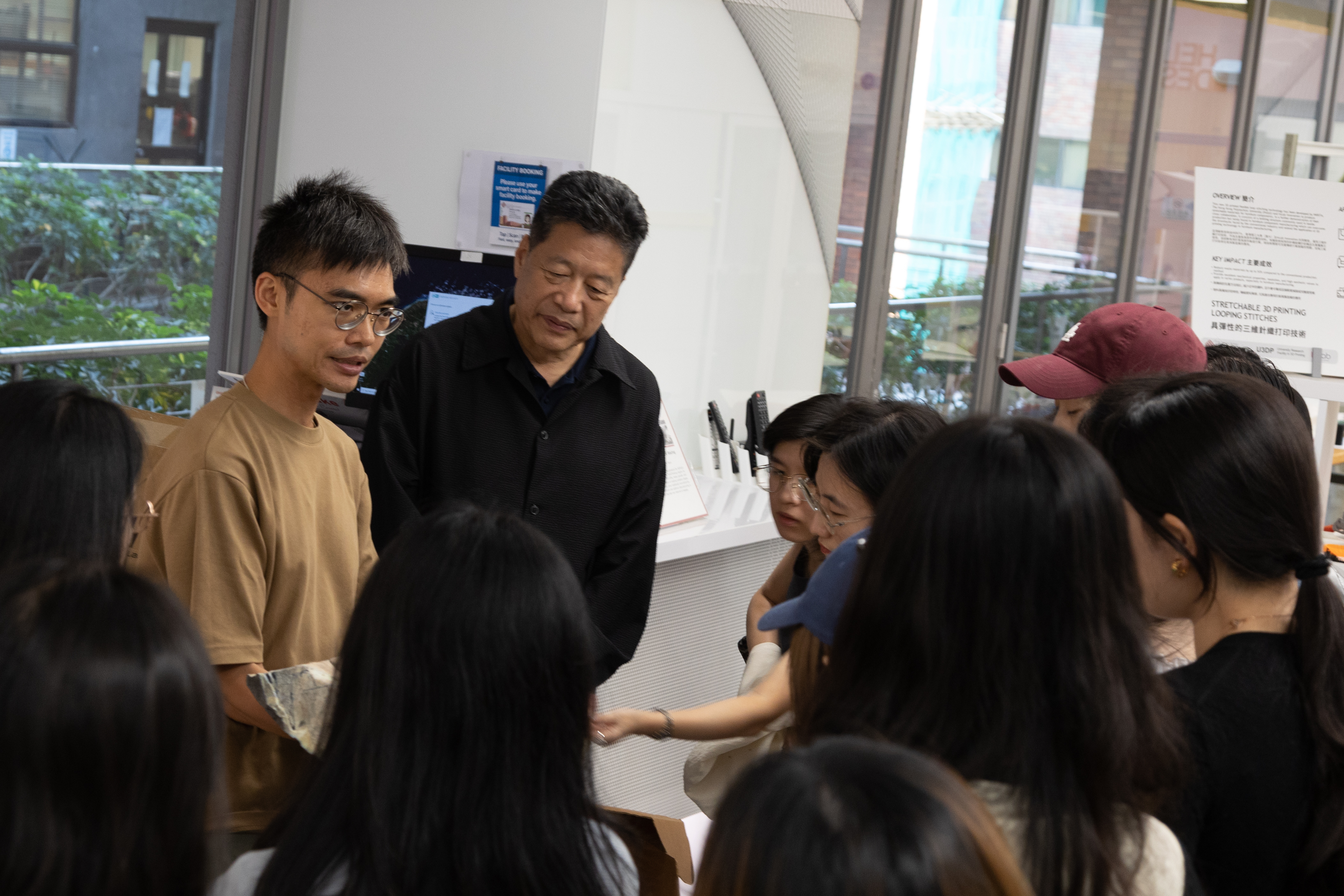 (From left) Staff from PolyU’s University Research Facility in 3D Printing (U3DP) guiding Prof. Jiang Kinor (Deputy Director of JCTC, Professor of SFT, PolyU), guests, and students through the facility while presenting 3D-printed samples.