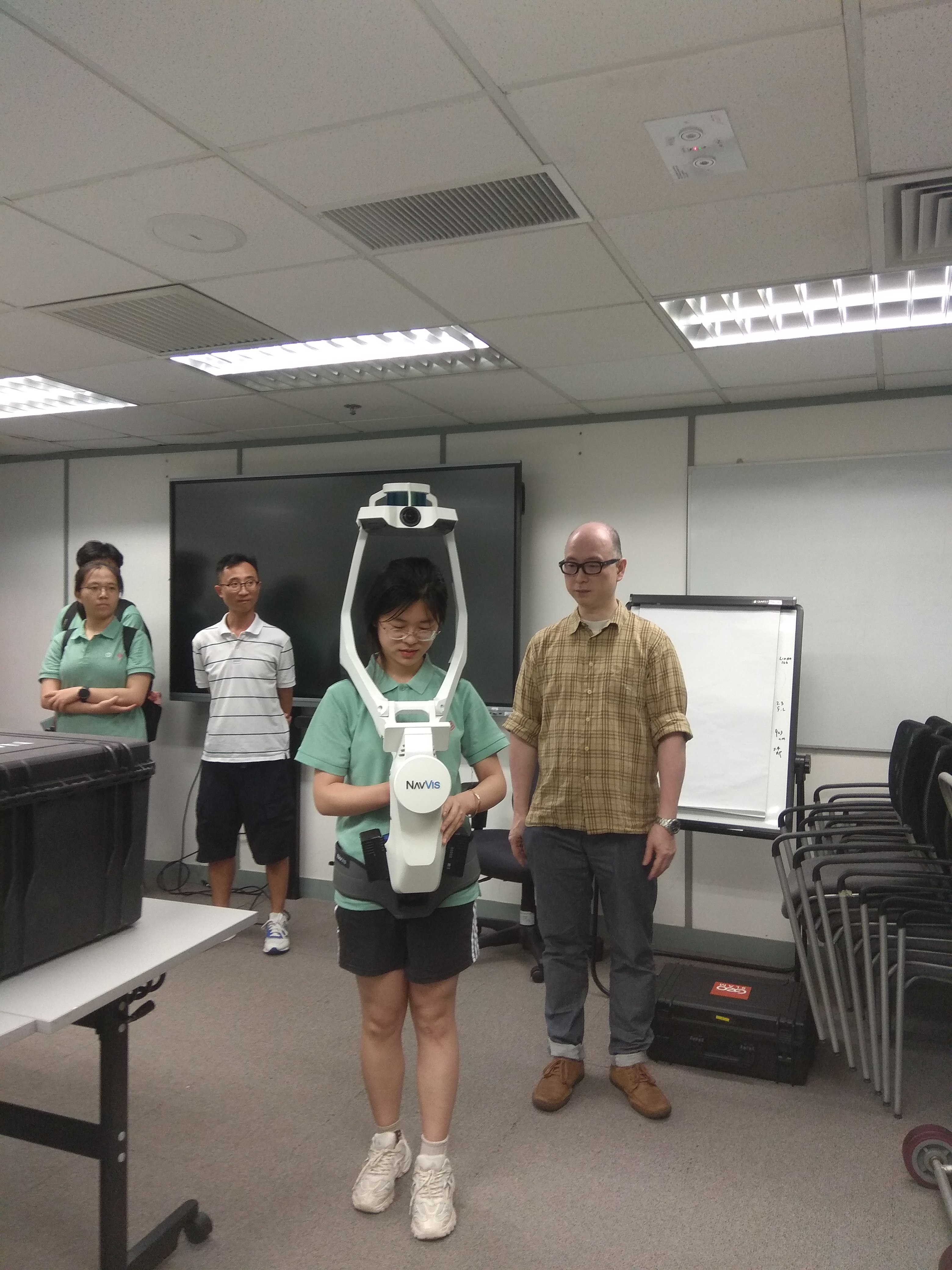 Students try the latest surveying equipment during visit to the Survey and Mapping Office.