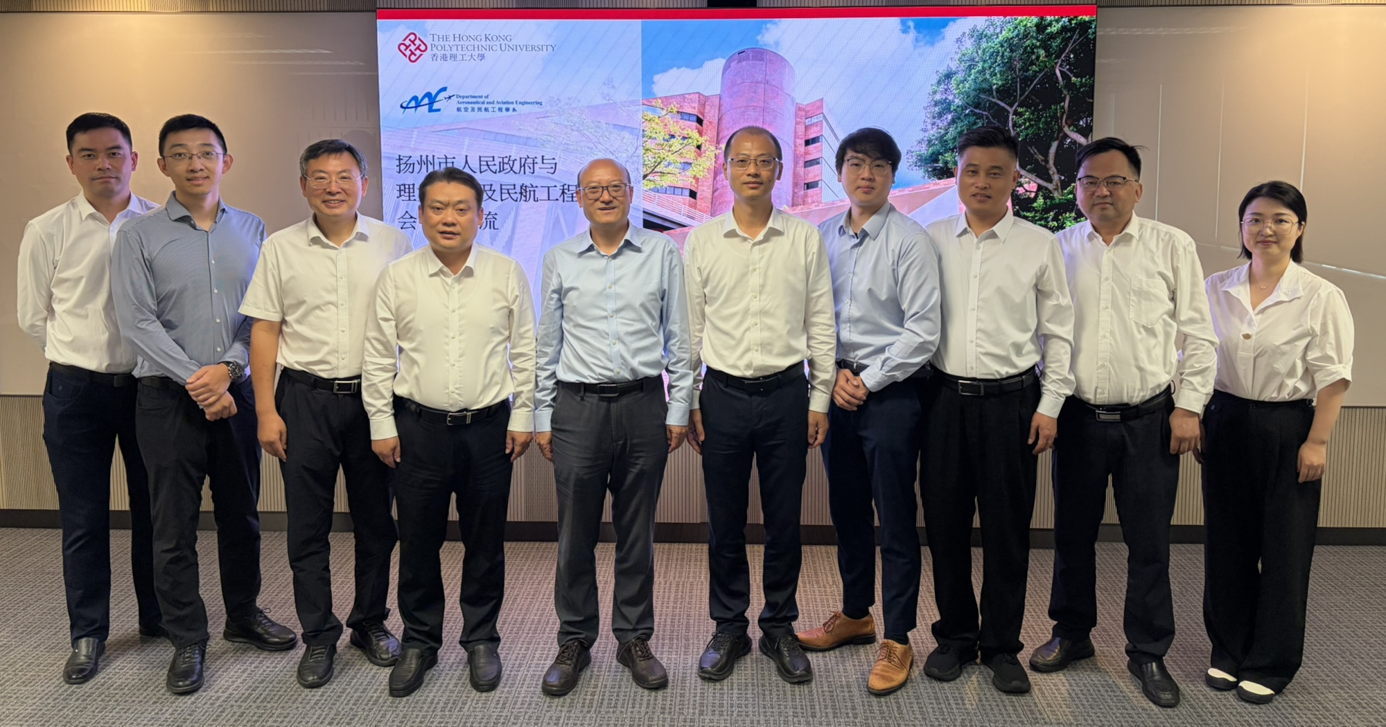 Prof. Wen-Hua Chen, Head of the Department of Aeronautical and Aviation Engineering (5th from left); Mr Chen Jun, Vice Mayor of Yangzhou (5th from right); and other guests pose for a group photo.