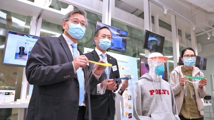 (Photos 1 & 7) From left: Prof. H. C. Man, Dean of the Faculty of Engineering and Director of University Research Facility in 3D Printing; Prof. Alexander Wai Ping-kong, Vice President (Research Development), Deputy President and Provost designate, PolyU; and Ms Yuen Woon-wah, Chief Infection Control Officer Office, Hospital Authority reveal the new 3D-printed face shield  (Photo 2) PolyU Council Chairman Dr Lam Tai-fai (first from right) and President Prof. Jin-Guang Teng (second from right) examine the face shields