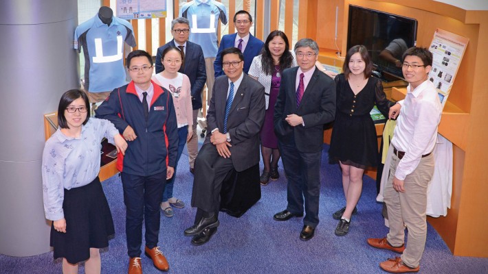 Professor Albert Chan (front row, third from left) with his research team, and Dr Francis Wong (third from right), Director of Hong Kong Institute of Construction