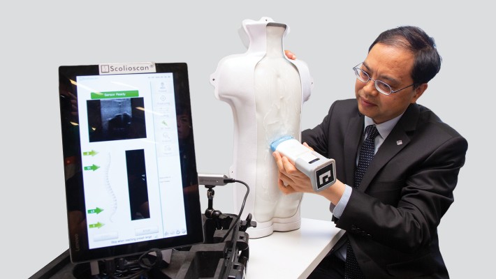 Ir Professor Zheng Yongping demonstrates the use of Scolioscan Air.