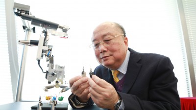 Professor Yung with the surgical robotic system.