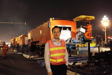 Mr Sze at Beijing's Chang'an Avenue with the hot-in-place recycling train at his back doing maintenance work for the avenue. 