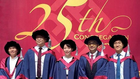 Dr Li Siyang (second from left) celebrates with his classmates on their graduation.