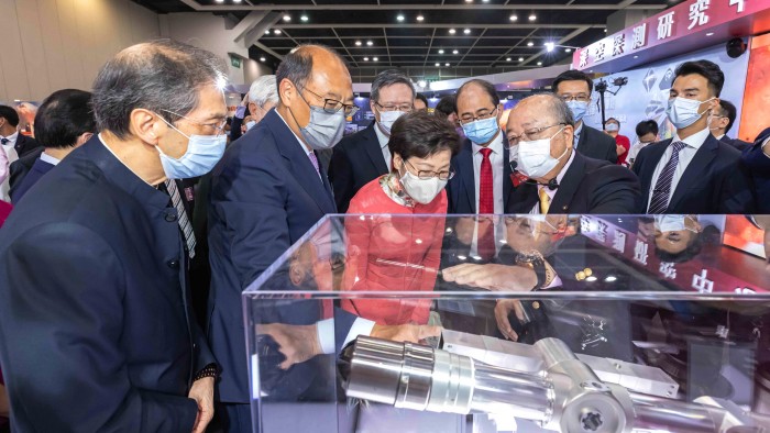 Chief Executive Mrs Carrie Lam (front, third from left) viewed the “Surface Sampling and Packing System” for collecting lunar soil by Chang’e-5, developed by the PolyU research team, led by Prof. Yung Kai-leung (front, fourth from left), Chair Professor of Precision Engineering and Director of the Research Centre for Deep Space Explorations. 