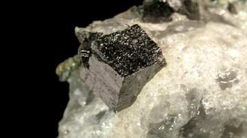 Unlocking Spin Coherence in Chiral Perovskite Quantum Wells for Next-Generation Spintronics