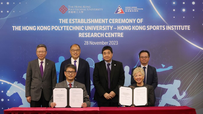 Witnessed by Dr Lam Tai-fai, Council Chairman of PolyU (back row, 2nd from left); Prof. Jin-Guang Teng, President (backrow, 1st from left); HKSI representatives including Mr Tony Choi Chief Executive Designate (back row, 2nd from right) and Dr Raymond So, Director of Elite Training Science & Technology (back row, 1st from right), the MoU was signed by Prof. Christopher Chao, Vice President (Research and Innovation) of PolyU (front row, left ) and Dr Trisha Leahy, Chief Executive of the HKSI (front row, right).