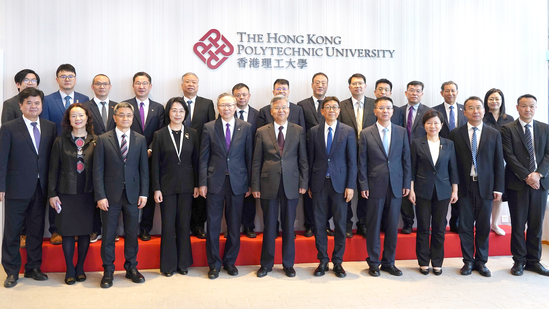 Mr Li Dianxun (front row, centre) led a delegation to visit PolyU and met with PolyU management including Prof. Jin-Guang Teng (front row, 5th from left) and Prof. Cao Jiannong (front row, 5th from right).