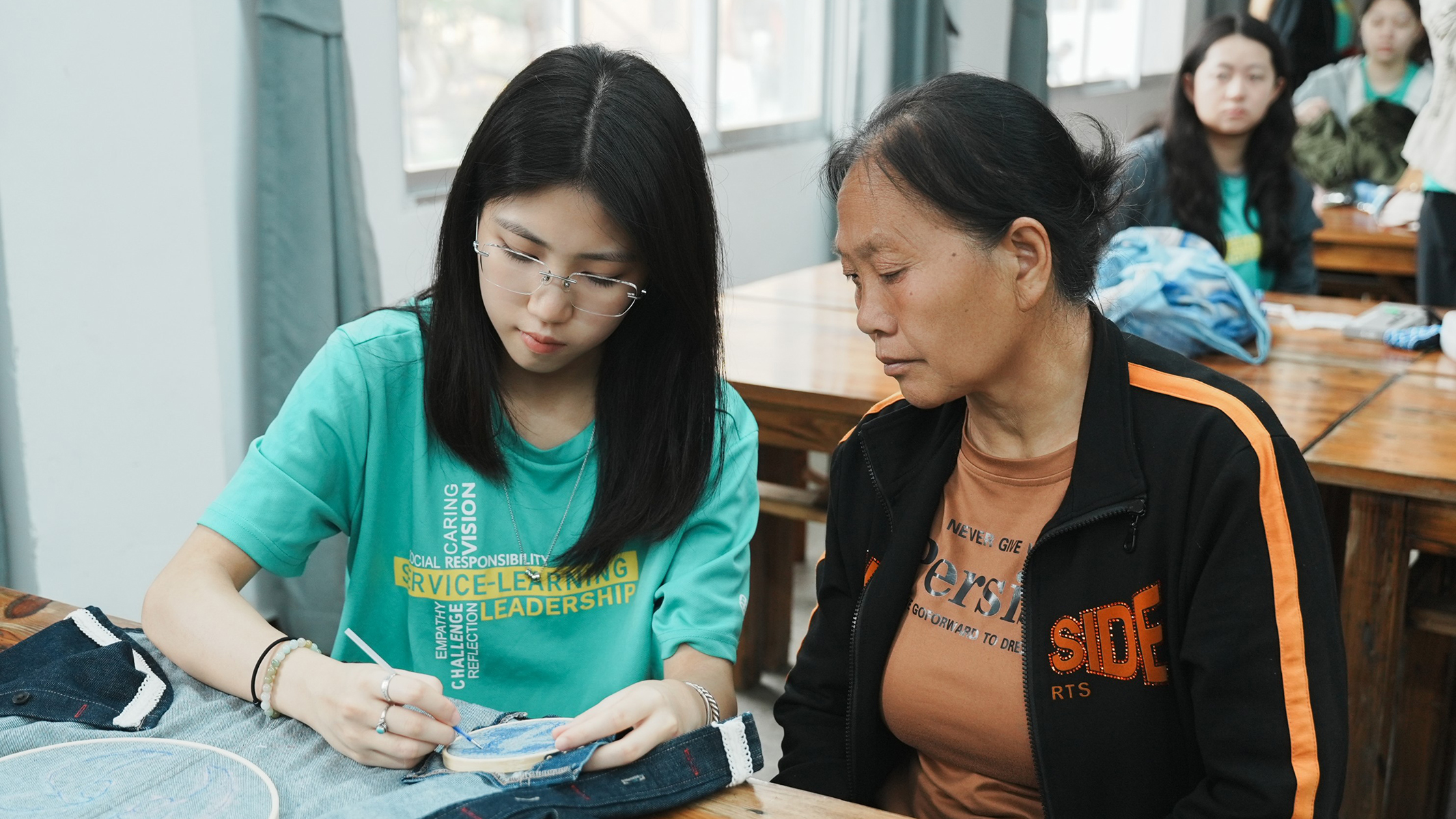 An SFT project saw students collaborate with embroidery artists to employ traditional Zhuang Embroidery techniques into vibrant, contemporary fashion design, promoting the inheritance of intangible cultural heritage.
