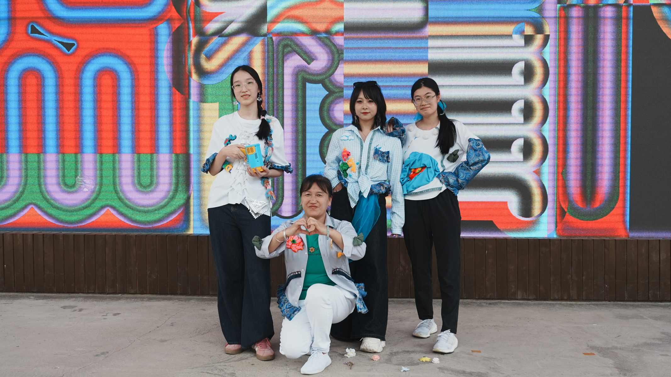 An SFT project saw students collaborate with embroidery artists to employ traditional Zhuang Embroidery techniques into vibrant, contemporary fashion design, promoting the inheritance of intangible cultural heritage.