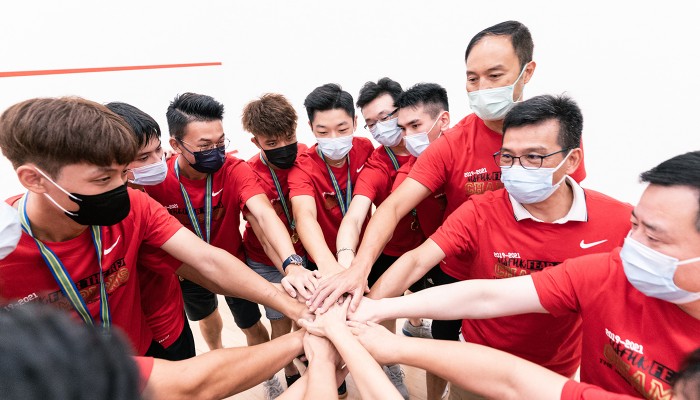 Kenny (second from right) and Kenneth (third from right) lead a huddle with teammates before a play