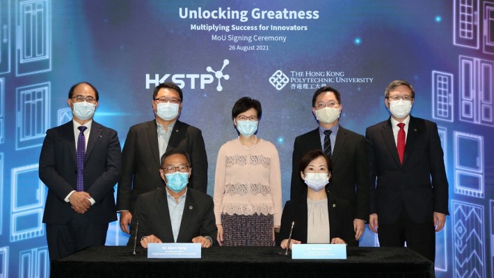 Dr Miranda Lou, PolyU’s Executive Vice President (seated, right) and Mr Albert Wong, CEO of HKSTP (seated, left), signed a strategic MoU to form the joint entrepreneurship programme, witnessed by Chief Executive Mrs Carrie Lam (back row, centre); Mr Alfred Sit, Secretary for Innovation and Technology (2nd from right); President Prof Jin-Guang Teng, PolyU (1st from right); Dr Sunny Chai, Chairman of HKSTP (2nd from left) and Prof Wing-tak Wong, Deputy President and Provost, PolyU.