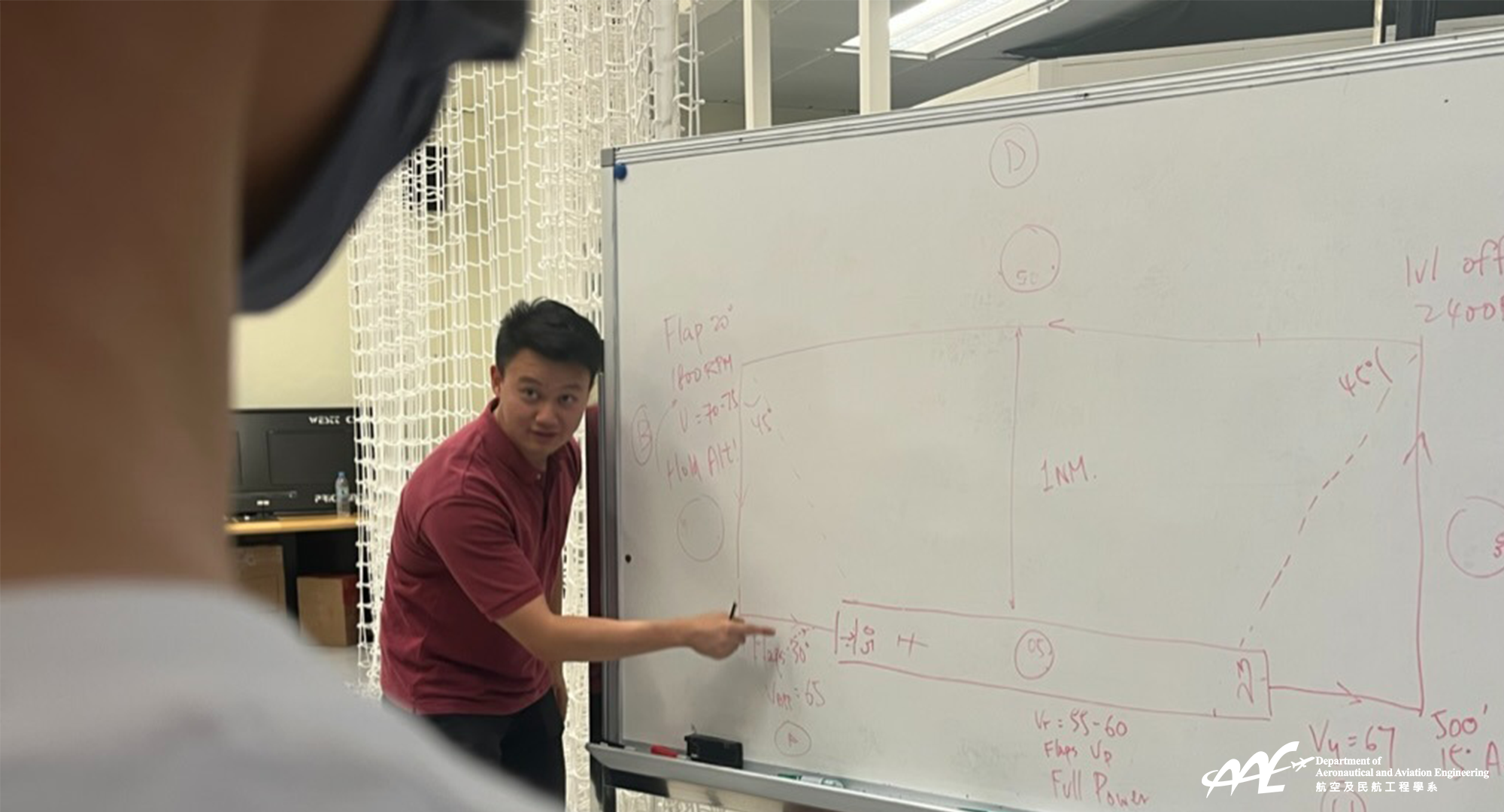 Mr Norman WONG Man Nok provides instruction to students in the flight simulation section of our lab.