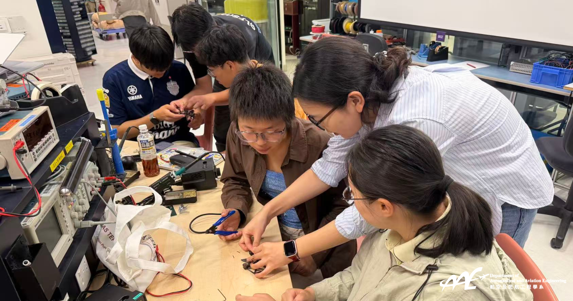 Participants assembling and conducting flight testing of small quadcopter drones during the hands-on sessions.